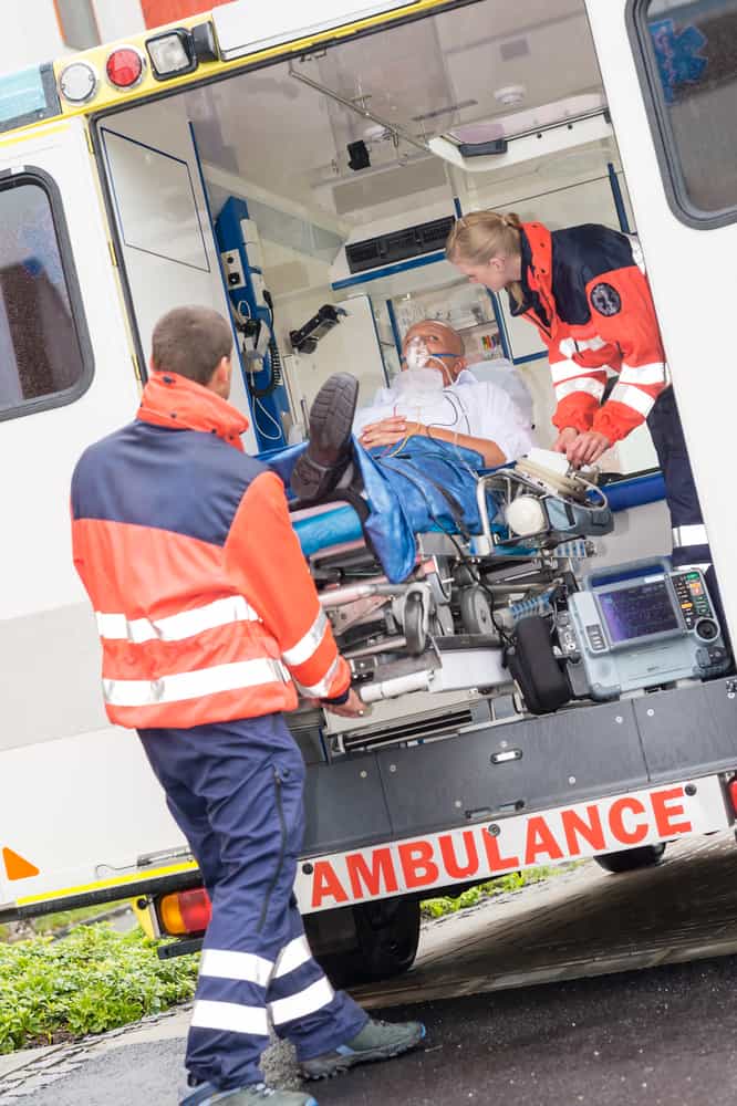 paramedics putting person into ambulance