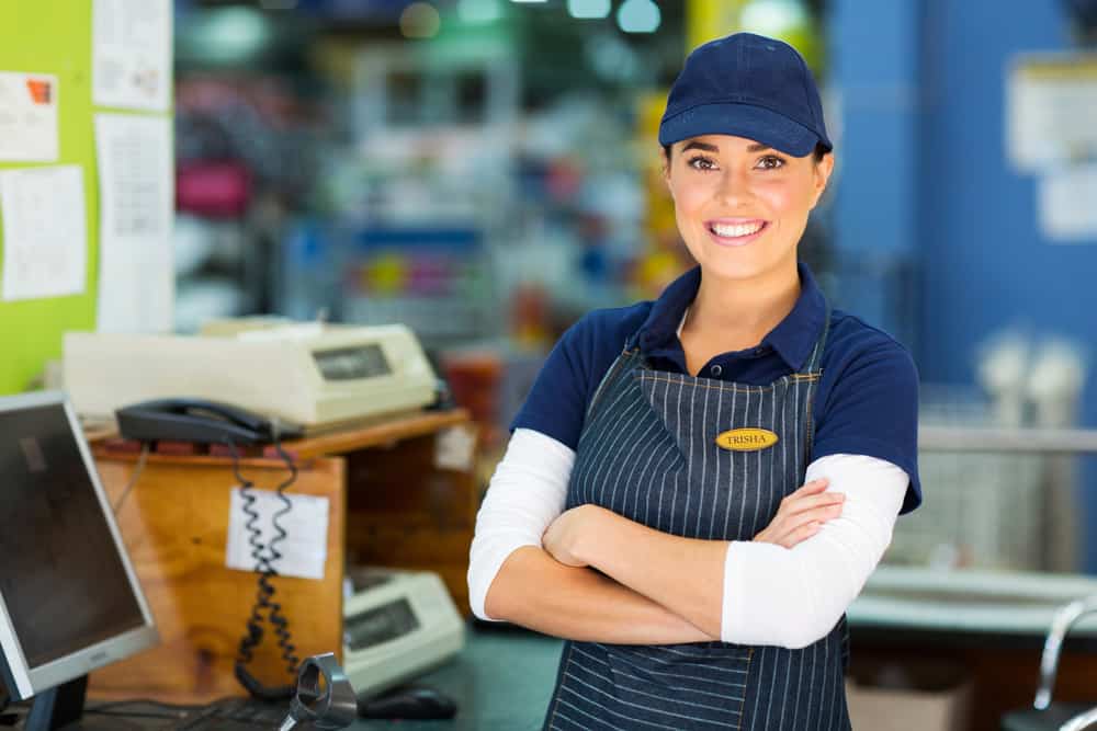 happy employee working at a register.