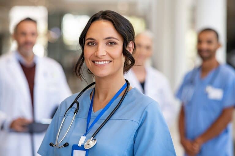 Smiling nurse with her clinical team in a hospital
