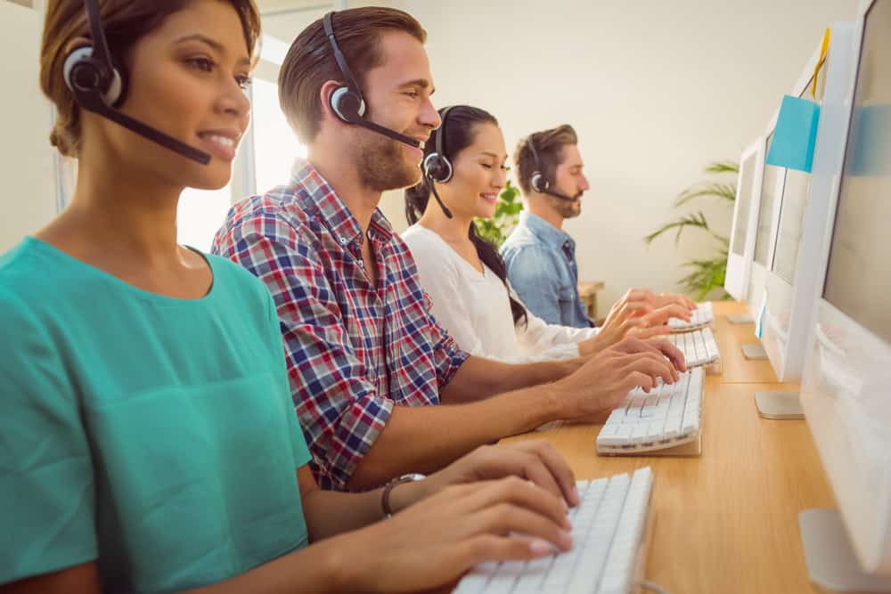 customer support staff working on computers and headsets.