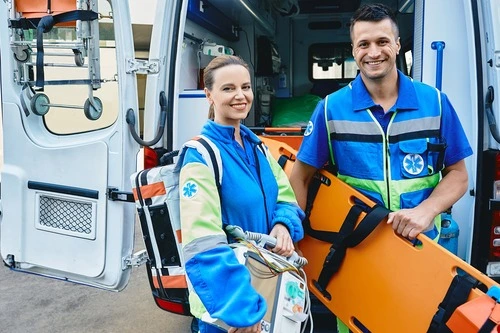 Paramedics standing by an ambulance ready to react to emergency calls.