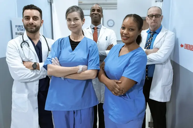 A medical emergency team posing in front of camera. These staff members were hired through an onsite staffing manager from StaffDash.