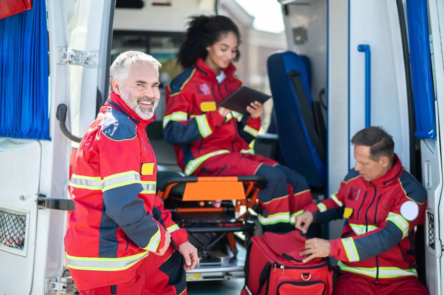 EMS crew of paramedics and EMTs getting their ambulance ready for a shift