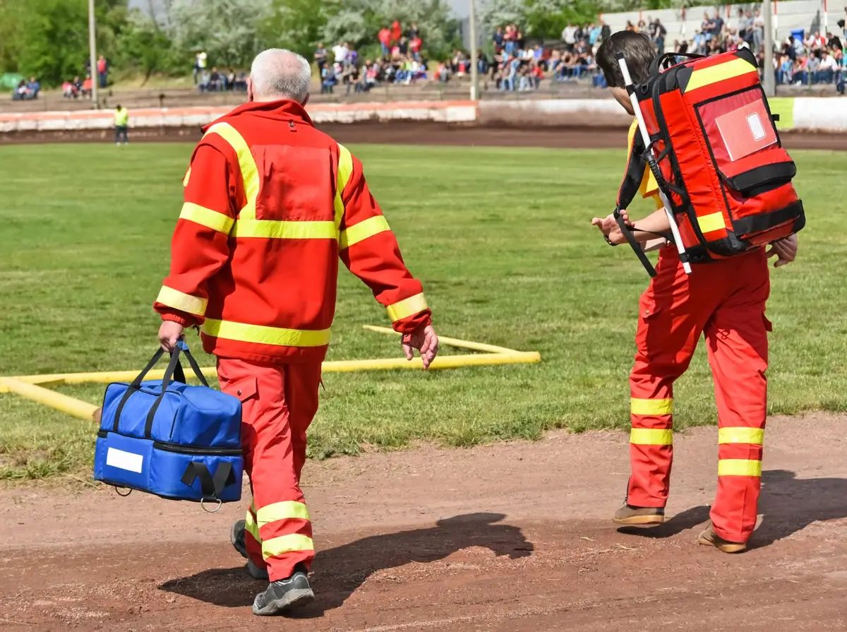 Standby medics walking onto a sports field during an event