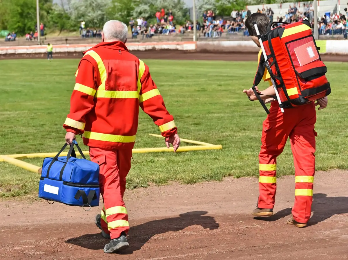 Standby medics walking onto a sports field during an event